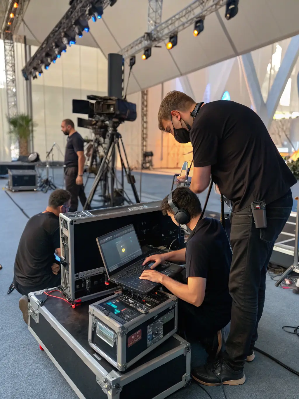 A technician setting up a wireless microphone system at a corporate event, ensuring presenters have the freedom to move and engage with the audience, showcasing the convenience of Top-Notch Event Tech's wireless solutions.
